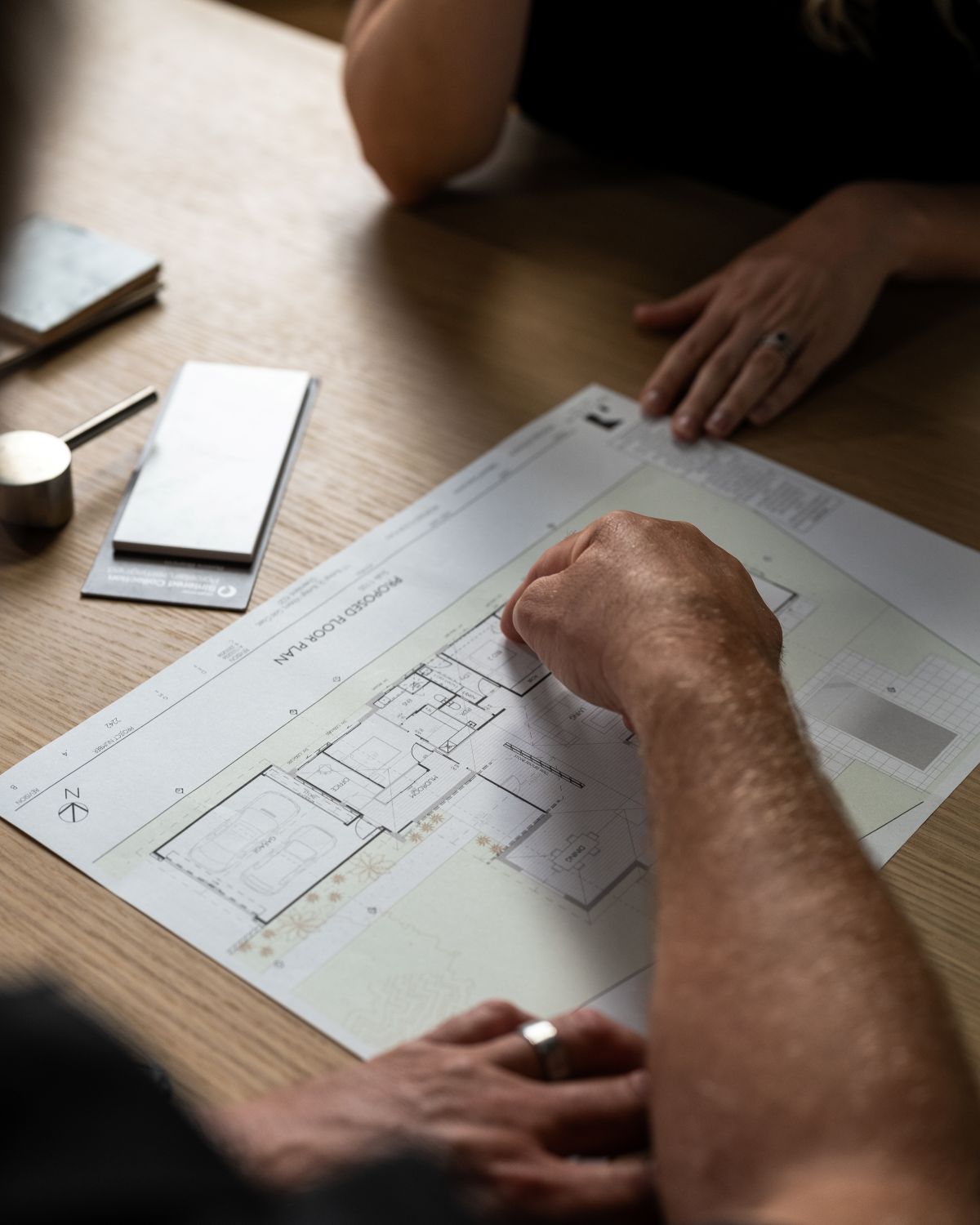Client and builder reviewing architectural plans for a home renovation on the Southern Gold Coast