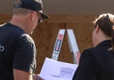 Builder looking over plans on site before starting a renovation on the Southern Gold Coast